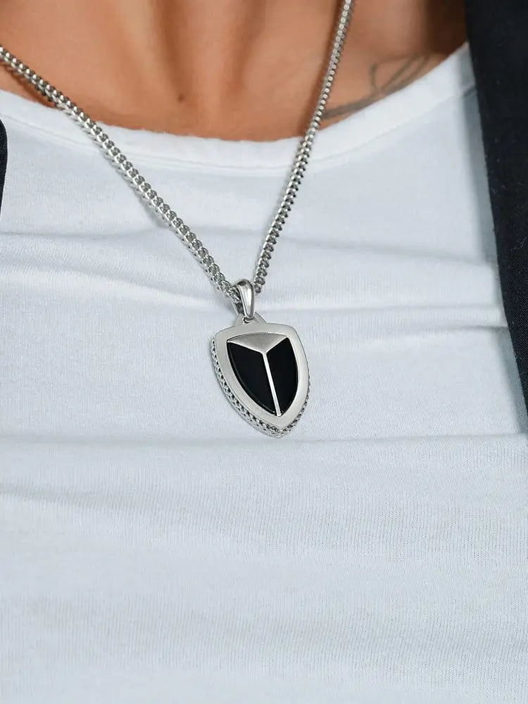 Silver shield-shaped black onyx pendant with beaded edge on a 316L stainless steel chain
