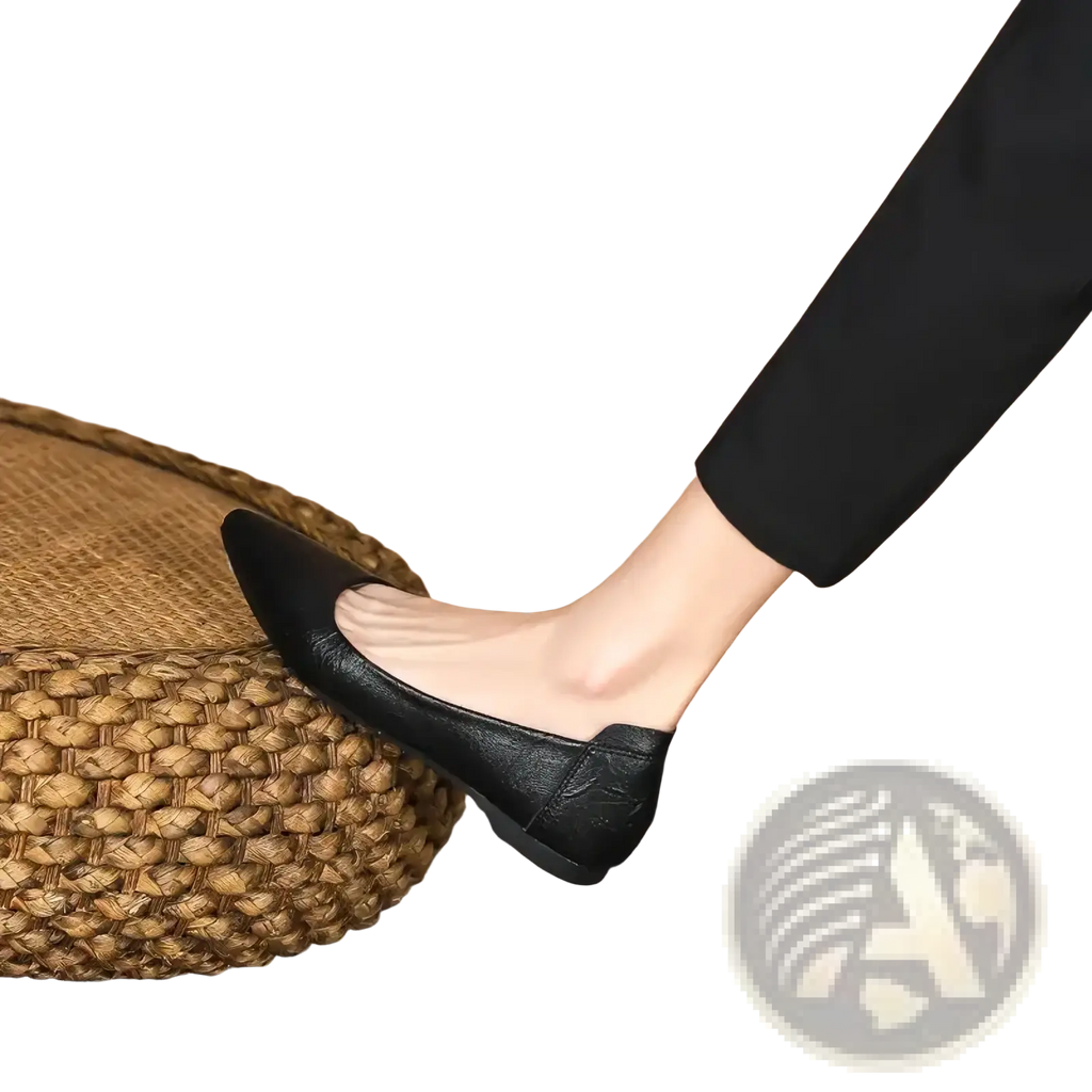 Black pointed toe leather office flats with a subtle embossed texture and a sleek black finish