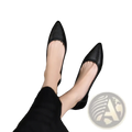 Black pointed toe leather office flats with textured upper and low heel perfect for professional wear