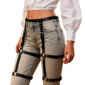 Black pu leather chest harness corset belt with metal hardware worn over light-wash jeans front view