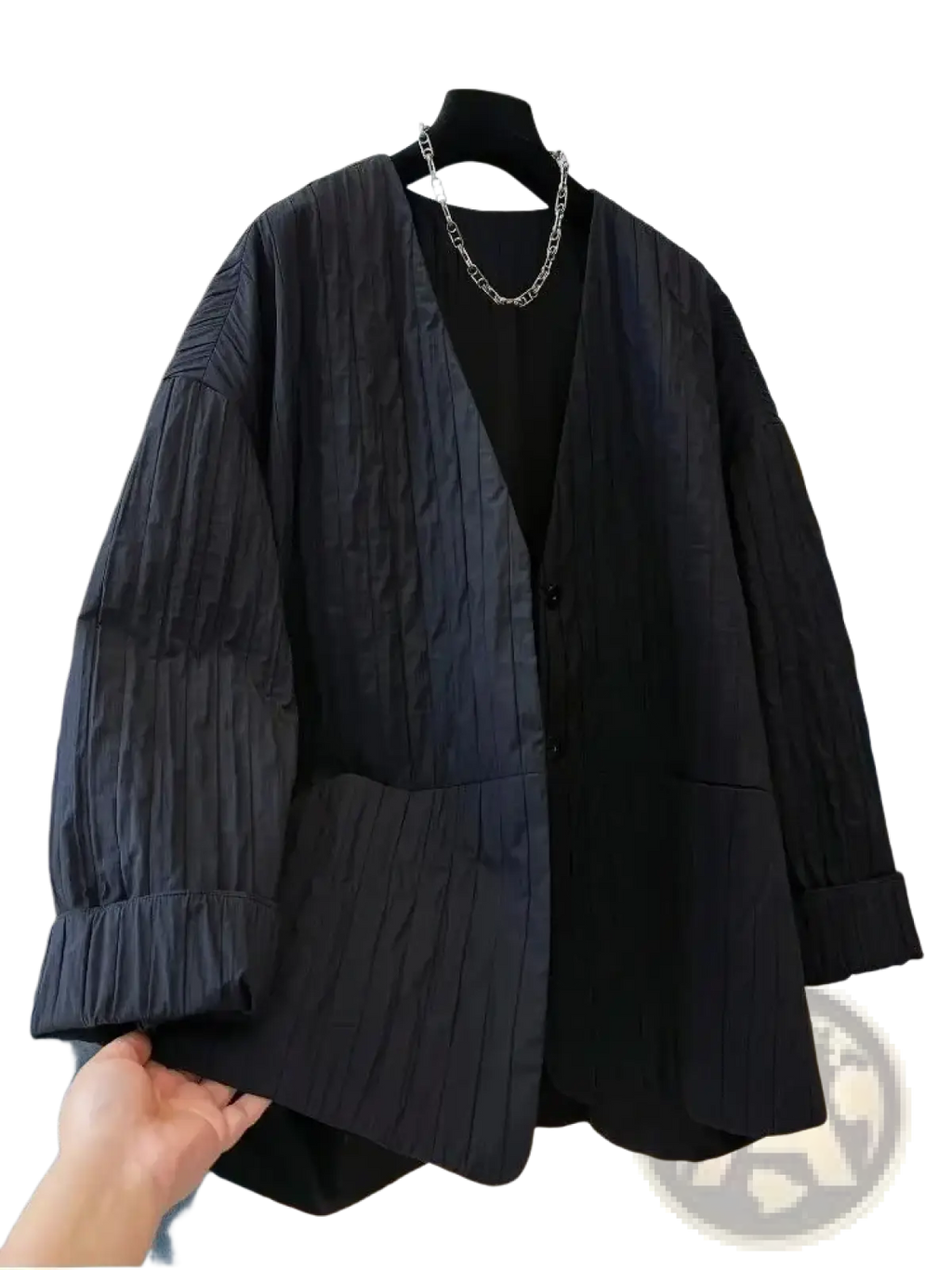 Black pleated blazer with relaxed fit and button closure paired with black quilted puffer winter parka jacket