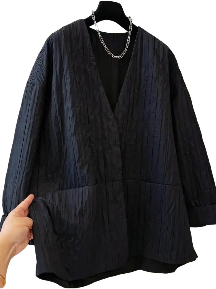 Black quilted puffer winter parka jacket with textured v-neck and large front pockets for cold weather use