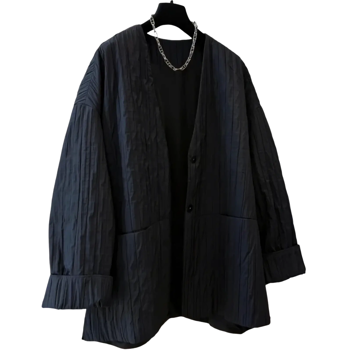 Black textured fabric cardigan with relaxed fit and button closure shown with black quilted puffer winter parka jacket
