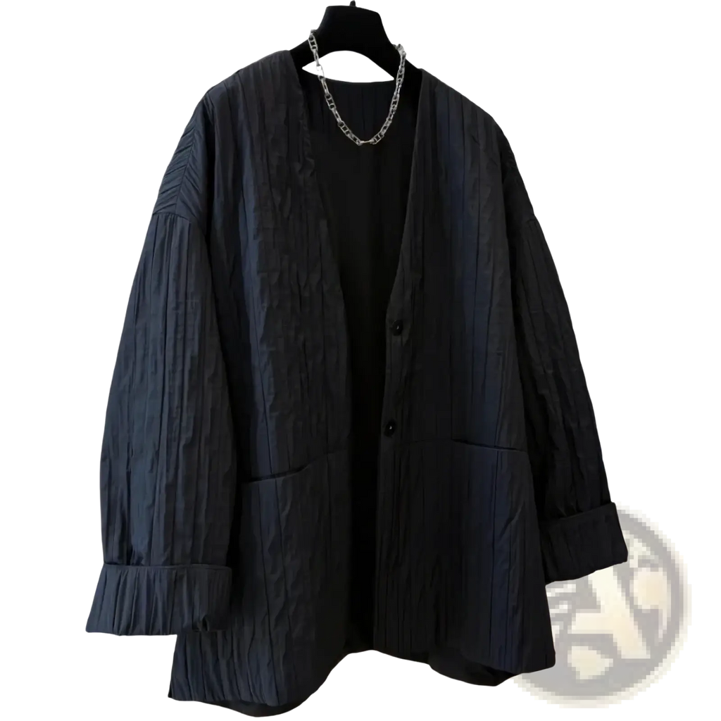 Black textured fabric cardigan with relaxed fit and button closure shown with black quilted puffer winter parka jacket
