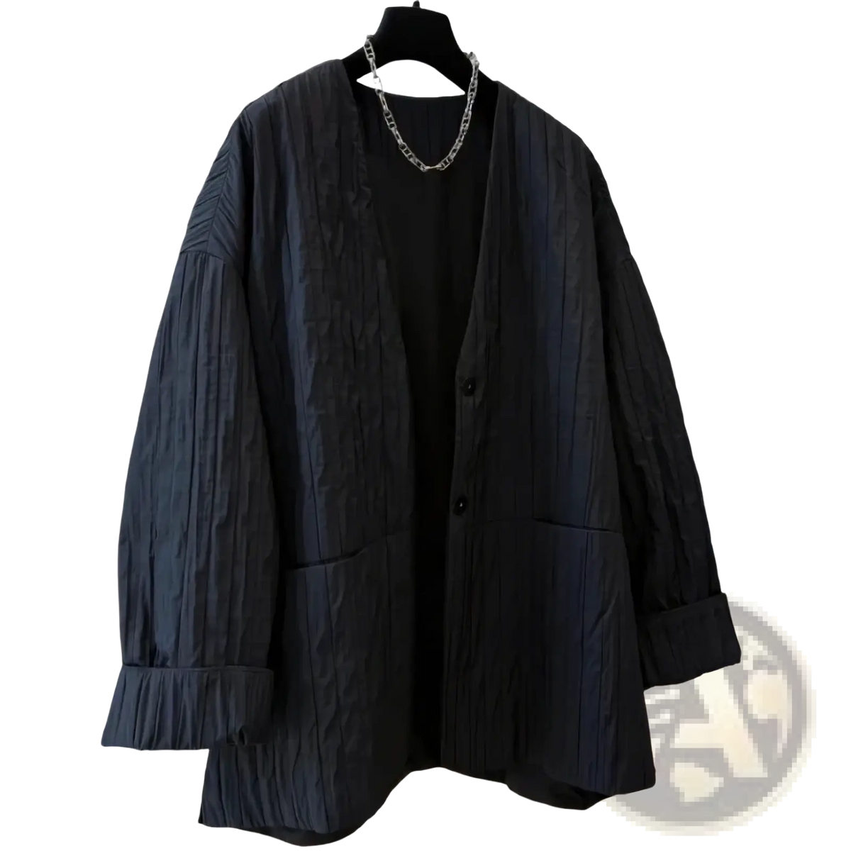 Black textured fabric cardigan with relaxed fit and button closure shown with black quilted puffer winter parka jacket