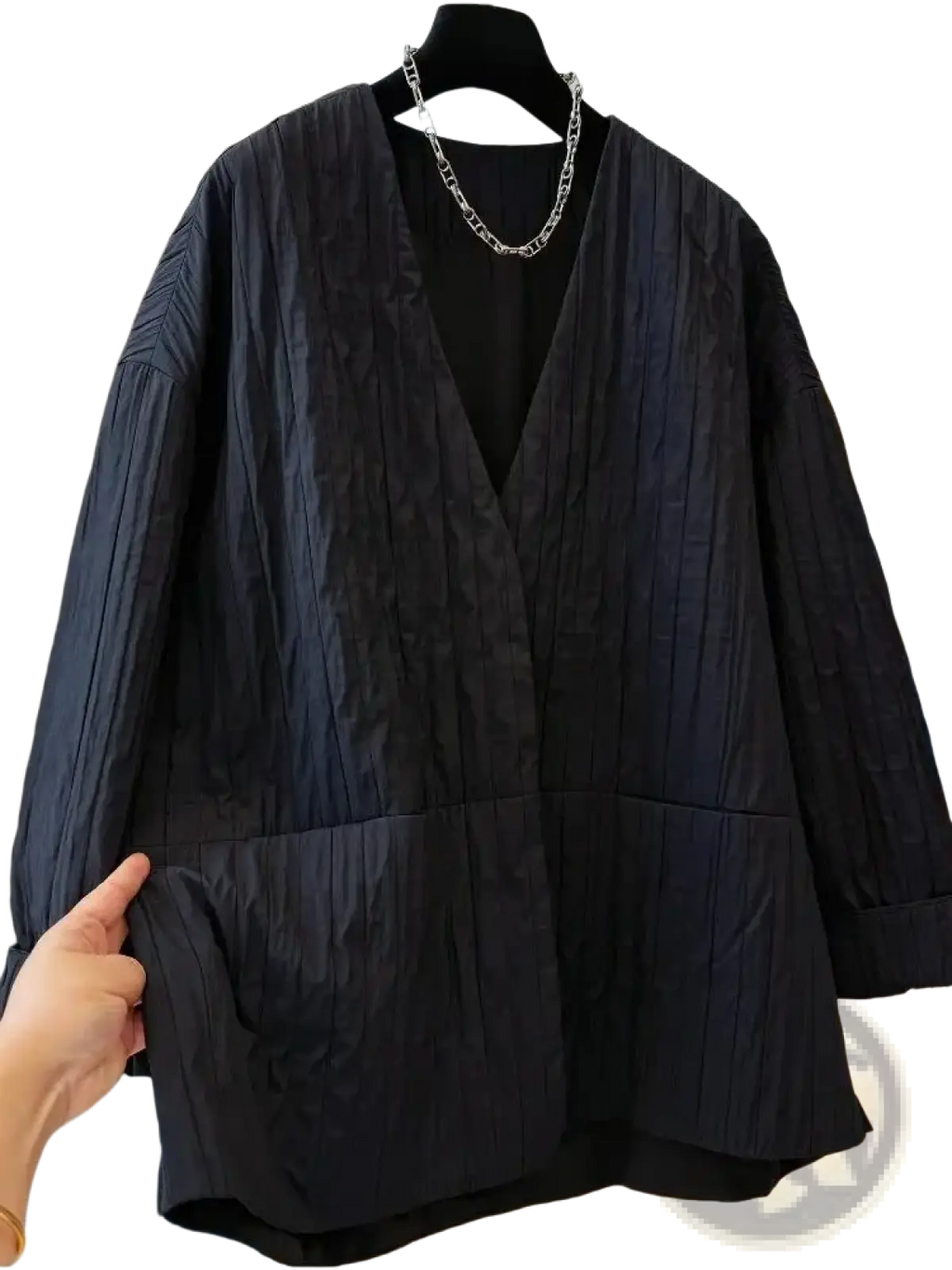 Black quilted puffer winter parka jacket with textured v-neck and large front pockets for cold weather use