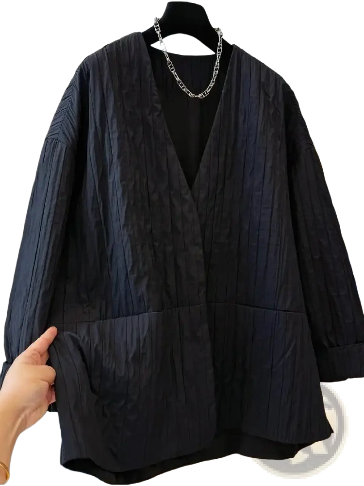 Black quilted puffer winter parka jacket with textured v-neck and large front pockets for cold weather use
