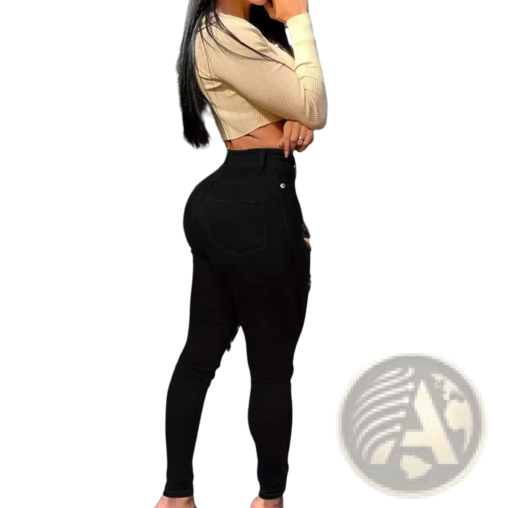 Black ripped high waisted skinny jeans featuring a sleek form fitting design in black denim material