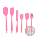 Set of six pink silicone kitchen utensils including spatulas knife and brush for baking and cooking tasks
