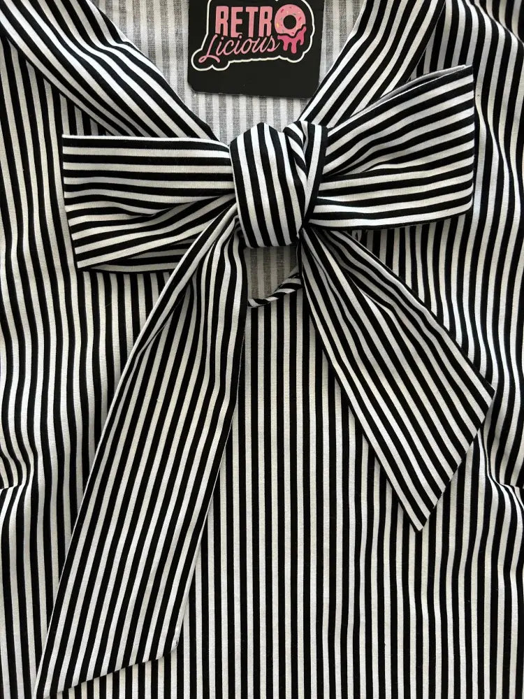 Vintage 1950s striped cotton blouse with black and white vertical stripes and a prominent matching bow at the neckline
