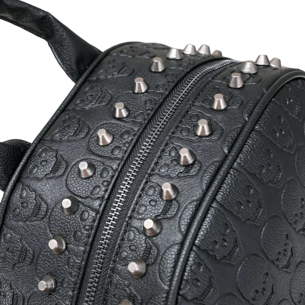 Black studded skull leather commute backpack featuring silver-toned studs and embossed skull patterns