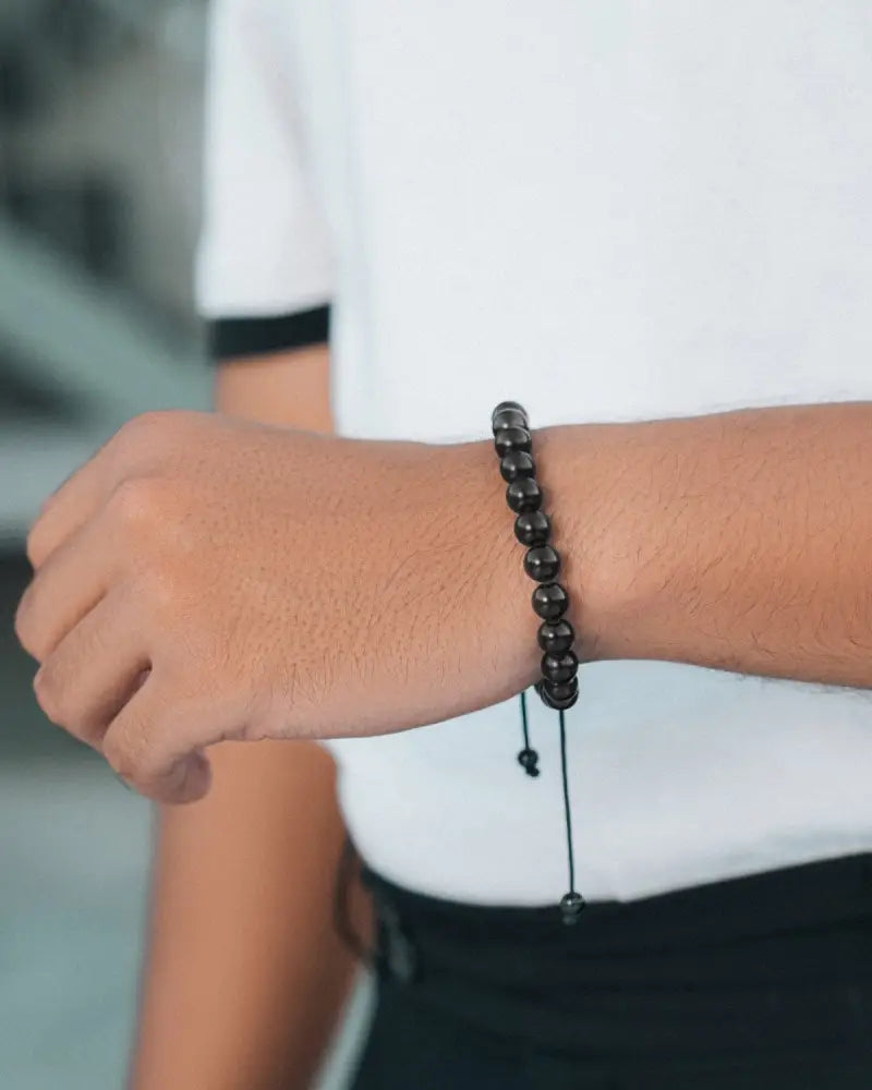 Aaa grade black tourmaline bali beaded bracelet with smooth round black stones and a thin adjustable cord