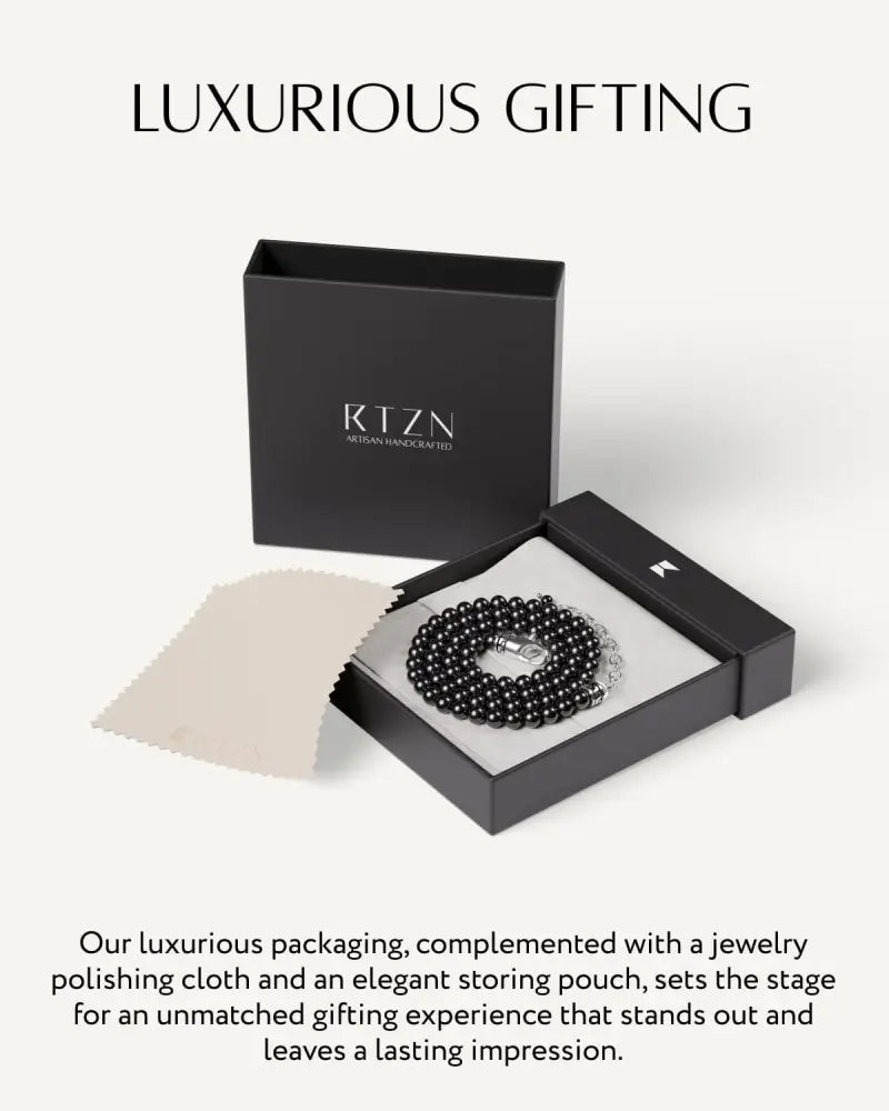 Black tourmaline beaded necklace with stainless steel silver clasp displayed in elegant black gift box