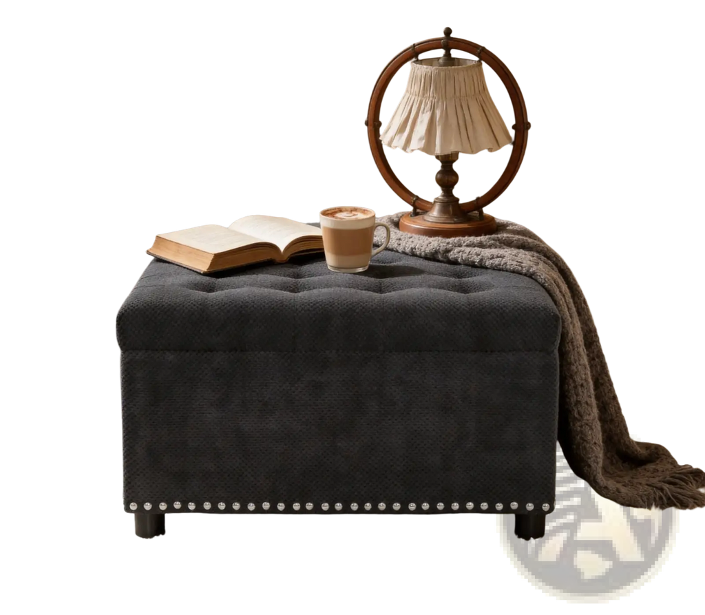 Black tufted storage ottoman in dark gray fabric with decorative nailhead trim along the base for storage use