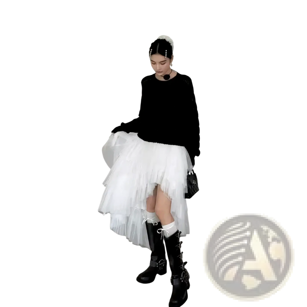 White layered tulle skirt with asymmetrical hemline paired with black knit top in a party dress ensemble