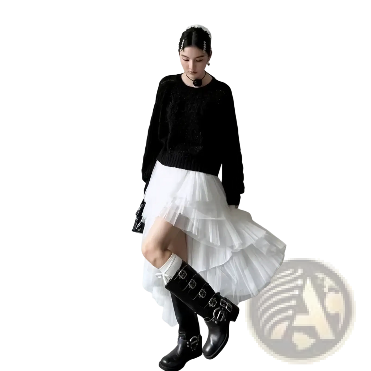 Black knee-high leather boots with silver buckle details paired with a black tutu party dress and asymmetric knit top
