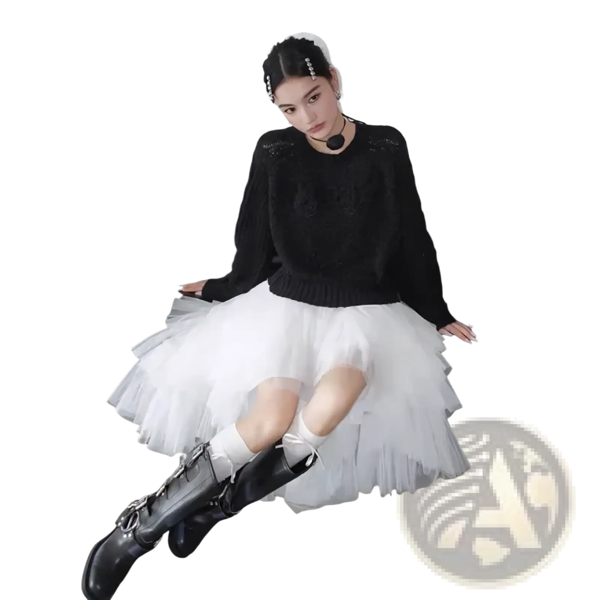 Black leather knee-high boots with silver buckle details complement the black tutu party dress with asymmetric knit top