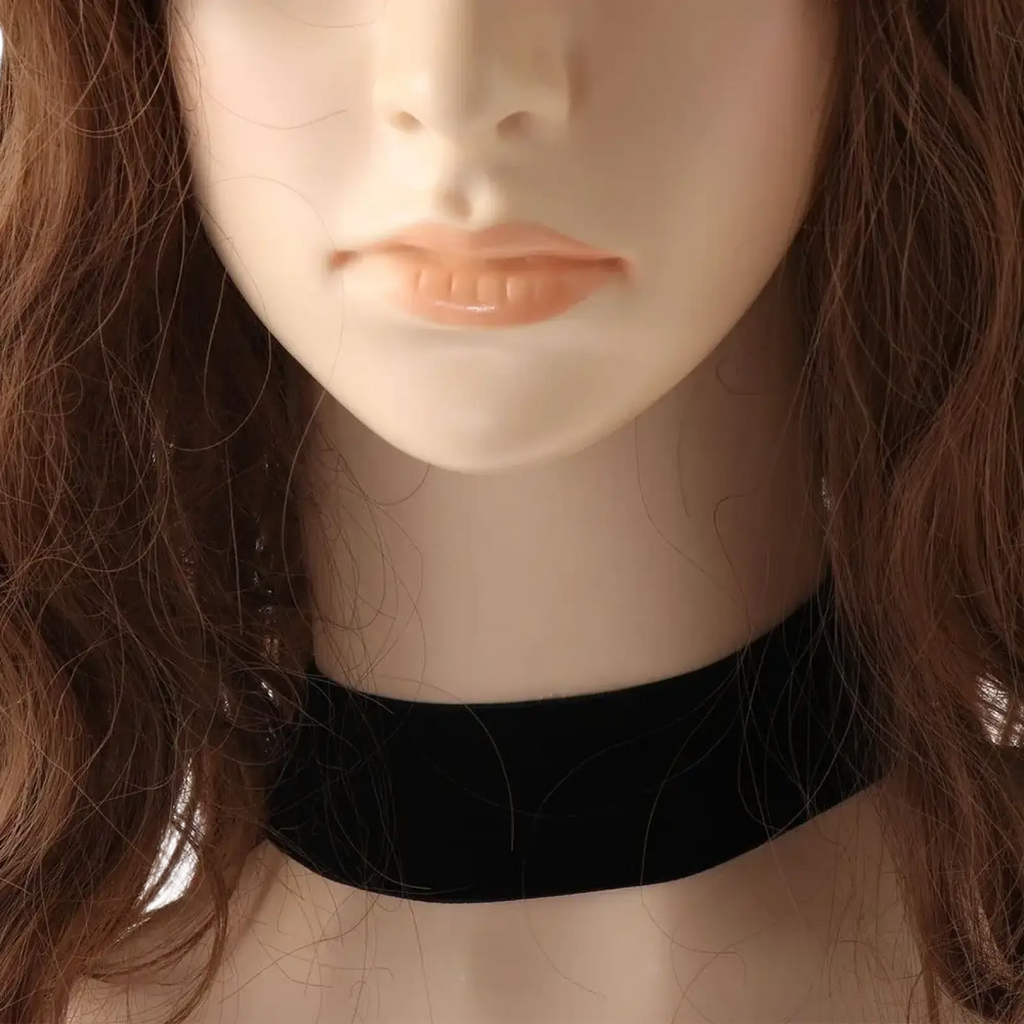 Black velvet choker necklace vintage gothic jewelry worn around a mannequin neck showcasing its elegant design