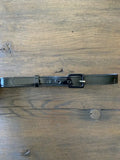 Retro black patent vinyl belt with silver eyelets featuring a sleek rectangular buckle and evenly spaced holes