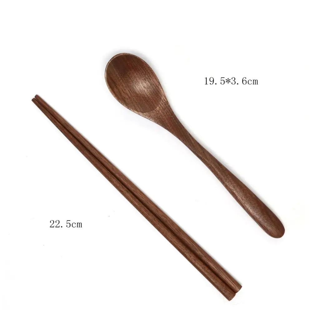 A pair of dark brown handcrafted black walnut wood chopsticks and matching spoon with smooth polished surfaces