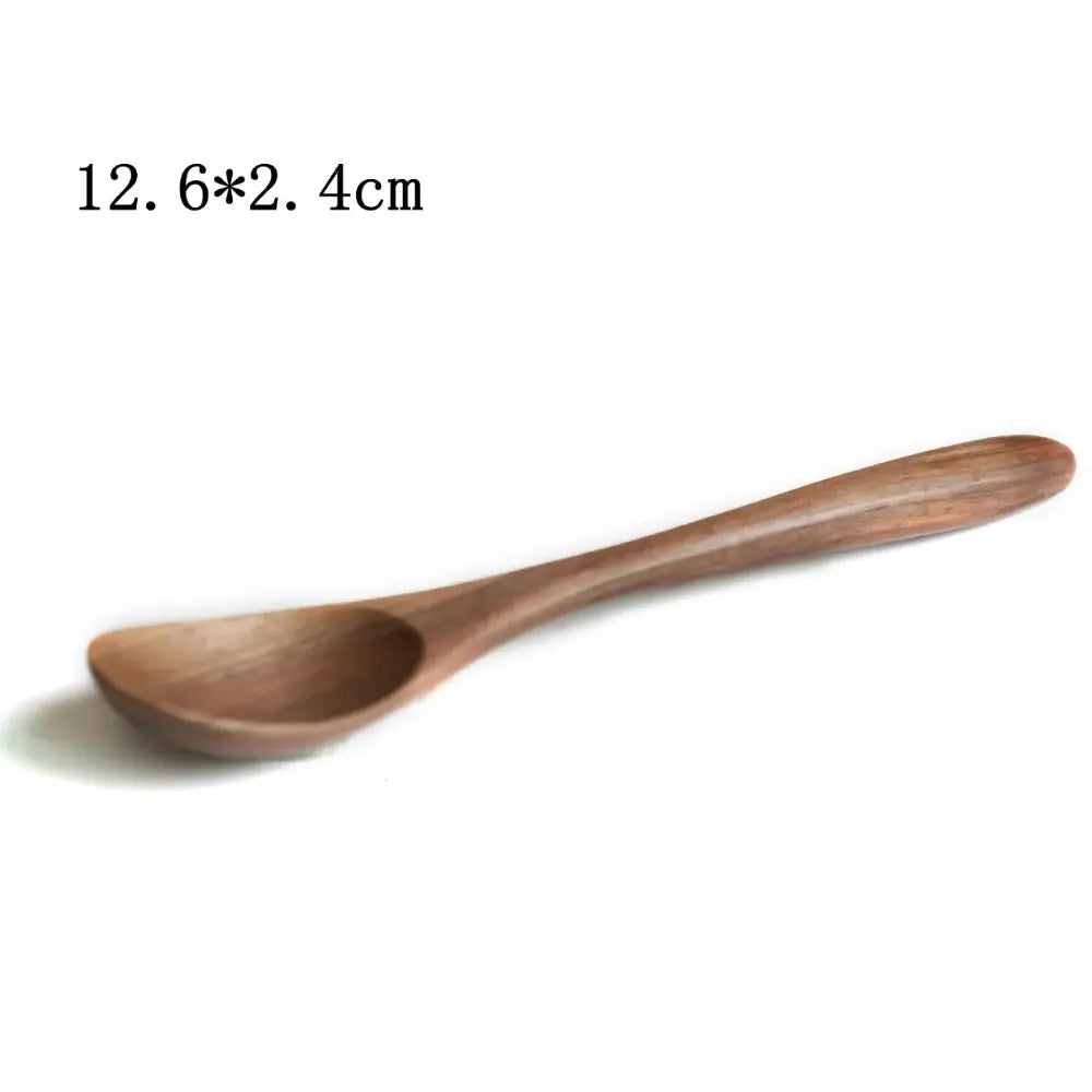 A smooth light brown handcrafted black walnut wood dining spoon with a gently curved handle and rounded bowl