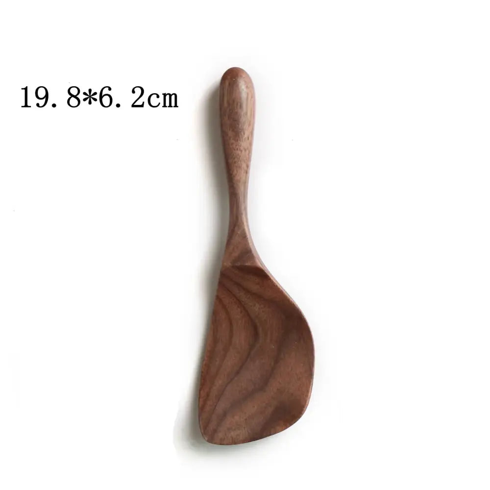 A smooth medium-brown wooden rice paddle with a curved handle in a handcrafted black walnut wood dining spoon set