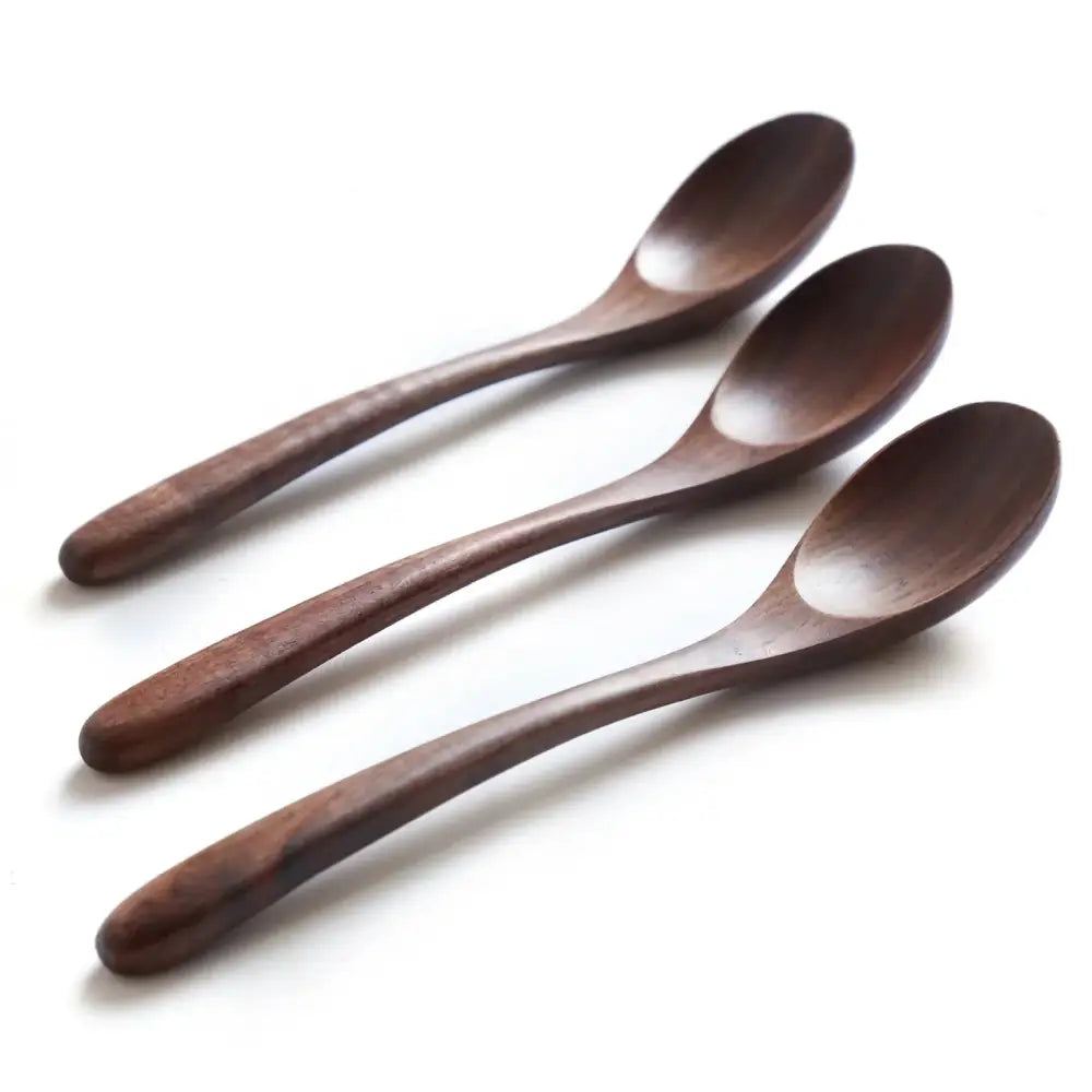 Set of three handcrafted black walnut wood dining spoons with dark brown polished surfaces and slender handles