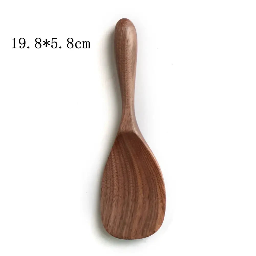 A smooth medium-brown wooden rice paddle with curved handle and concave scoop from handcrafted black walnut wood dining spoon set