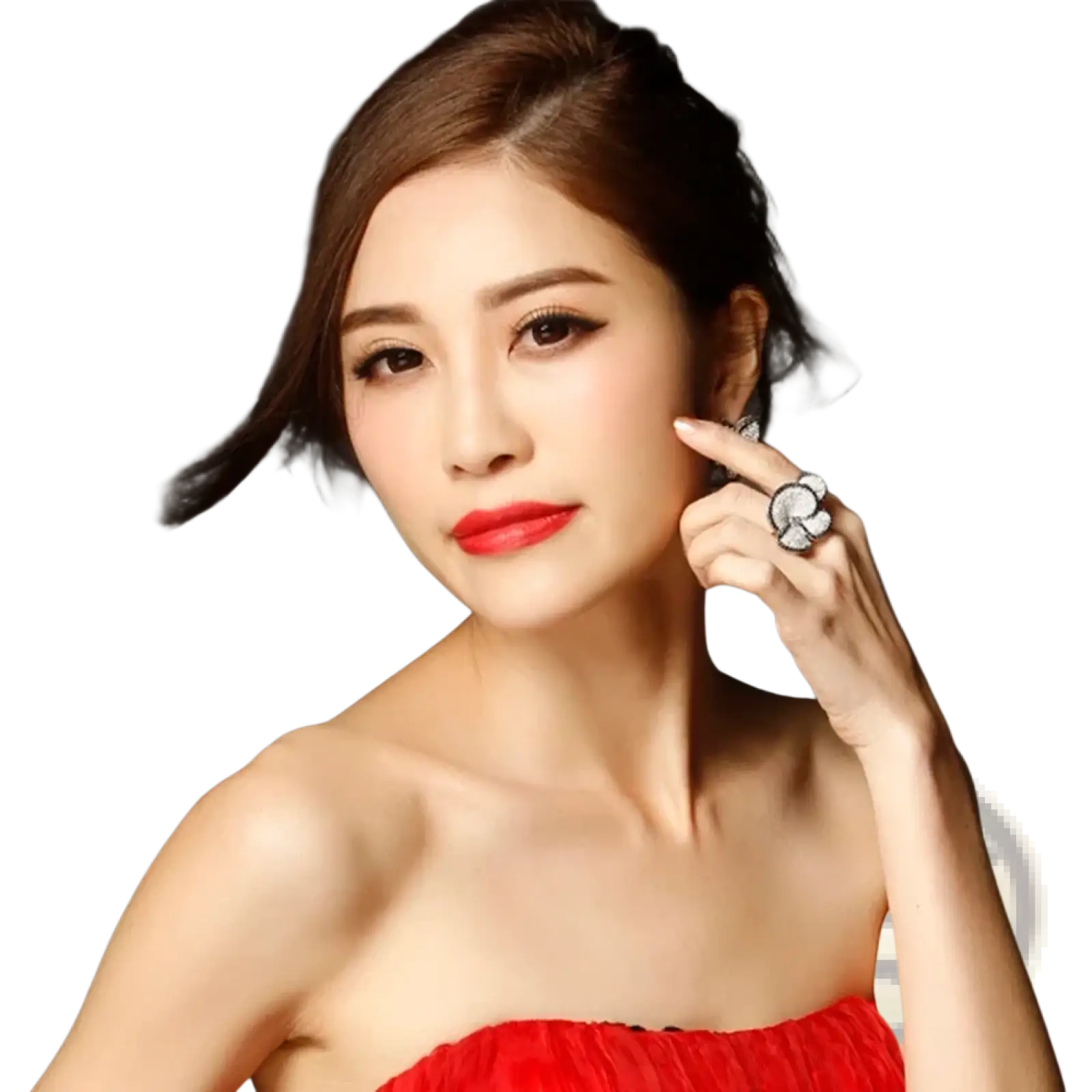 A woman wearing a vibrant red strapless dress with ruched detailing showcasing a black and white crystal statement flower ring