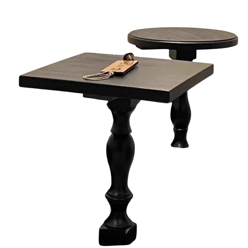 Black wooden pedestal round accent table with a black square top, ornate turned legs, and a matte finish