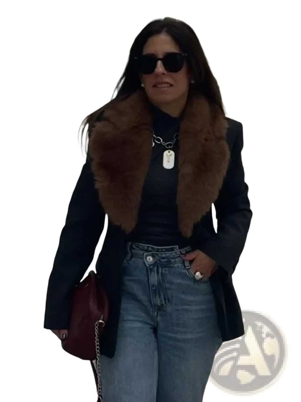 A burgundy leather handbag with a chain strap paired with a black wool coat with a fur collar