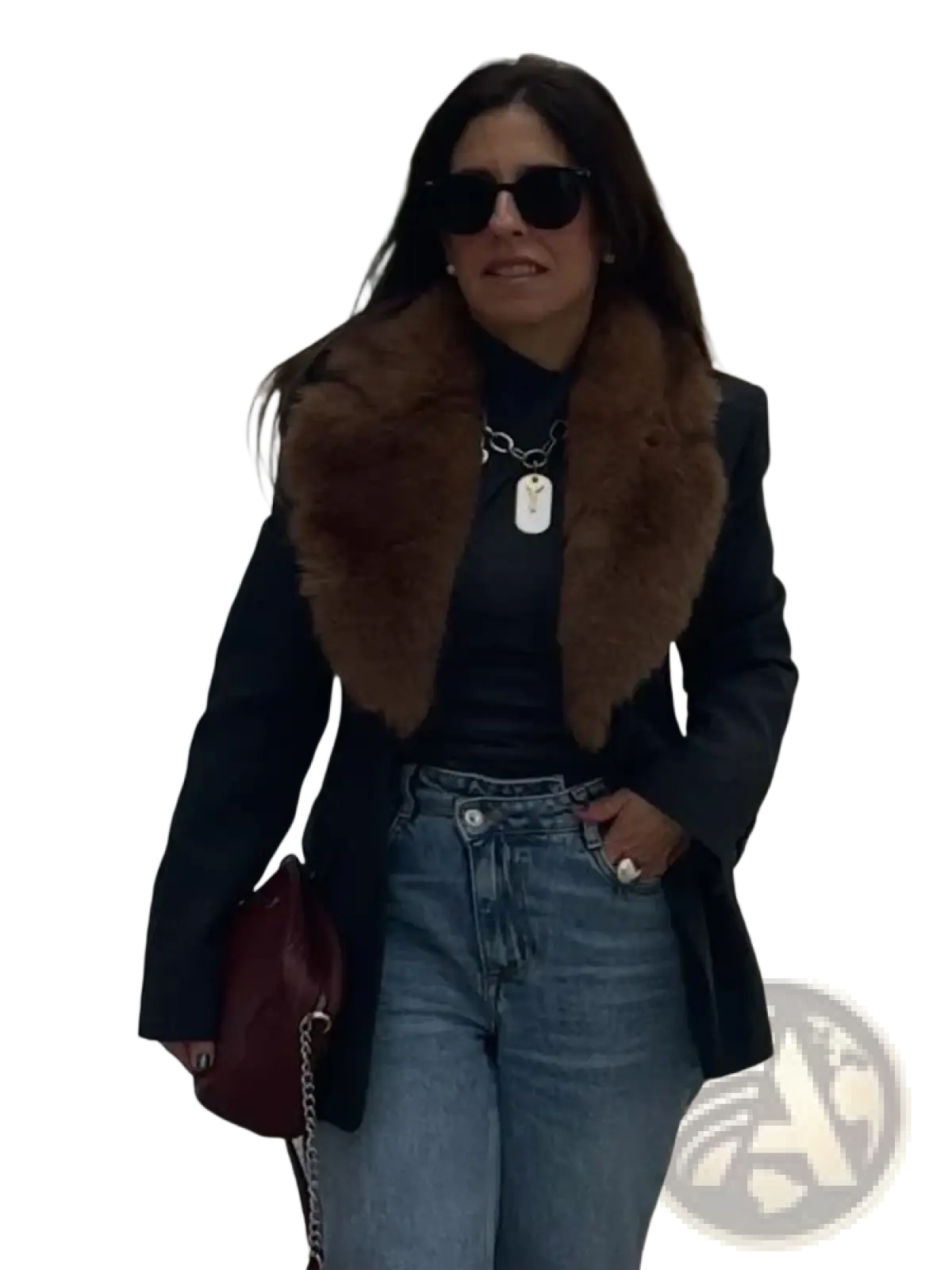 A burgundy leather handbag with a chain strap paired with a black wool coat with a fur collar