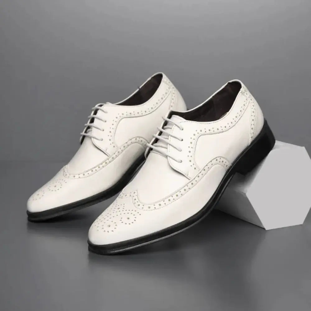 White leather men’s block carved brogue oxford dress shoes with black soles and laces for formal wear