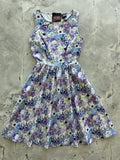Blossom Vintage 1950s floral cotton midi dress with pockets featuring a sleeveless floral print in lavender purple and blue hues
