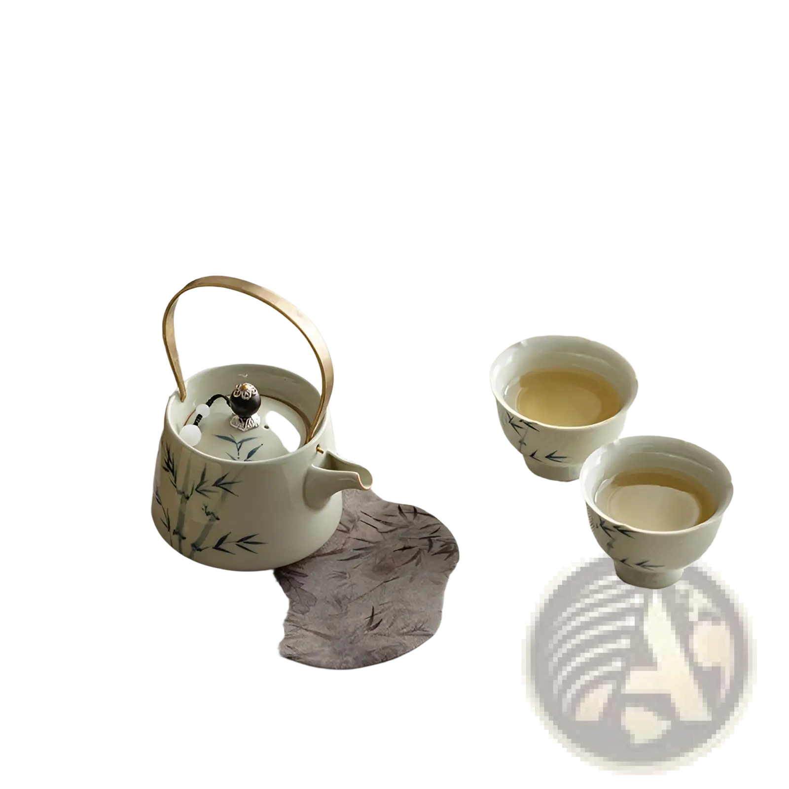 White ceramic blue bamboo teapot set with gold handle and bamboo leaf design on gray fabric mat