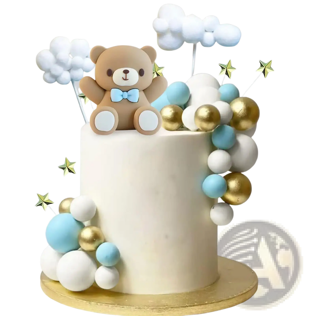 A beige teddy bear cake topper with a light blue bow tie sitting on a cloud and colorful spheres decorated cake