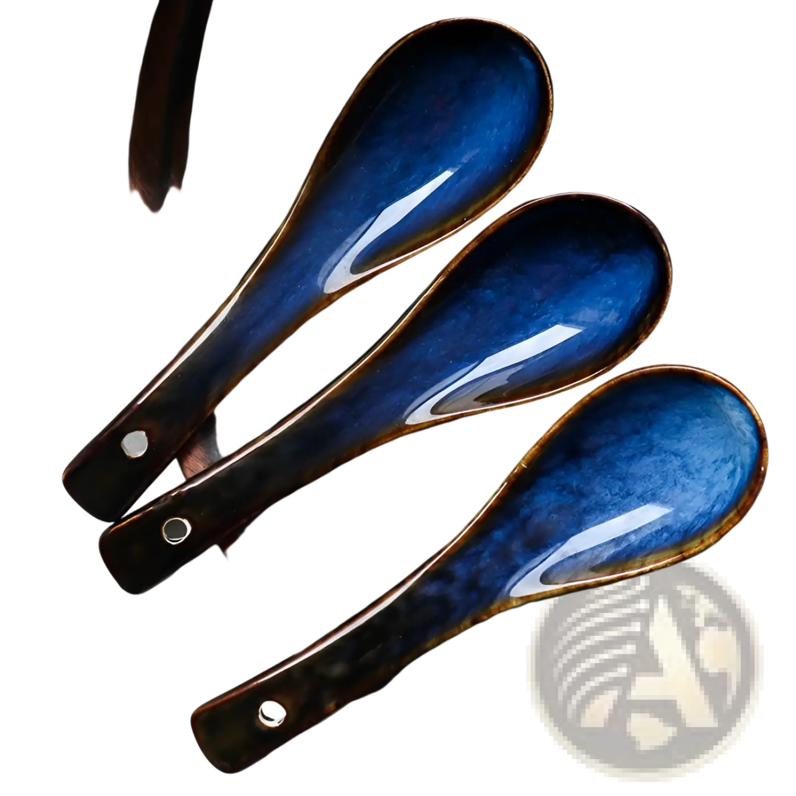 Three blue ceramic porcelain spoons with deep glaze and brown rim featuring a hole near the handle for tableware use