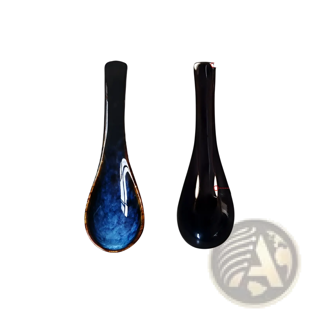 A sleek glossy black ceramic spoon with vibrant blue kiln glaze and gold rim for porcelain tableware use
