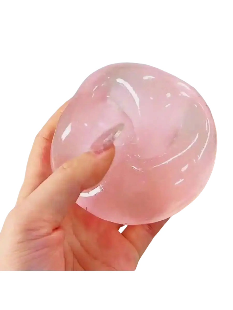 A translucent pink gel-like blue coconut oil stress relief squeeze ball with a smooth slightly glossy surface
