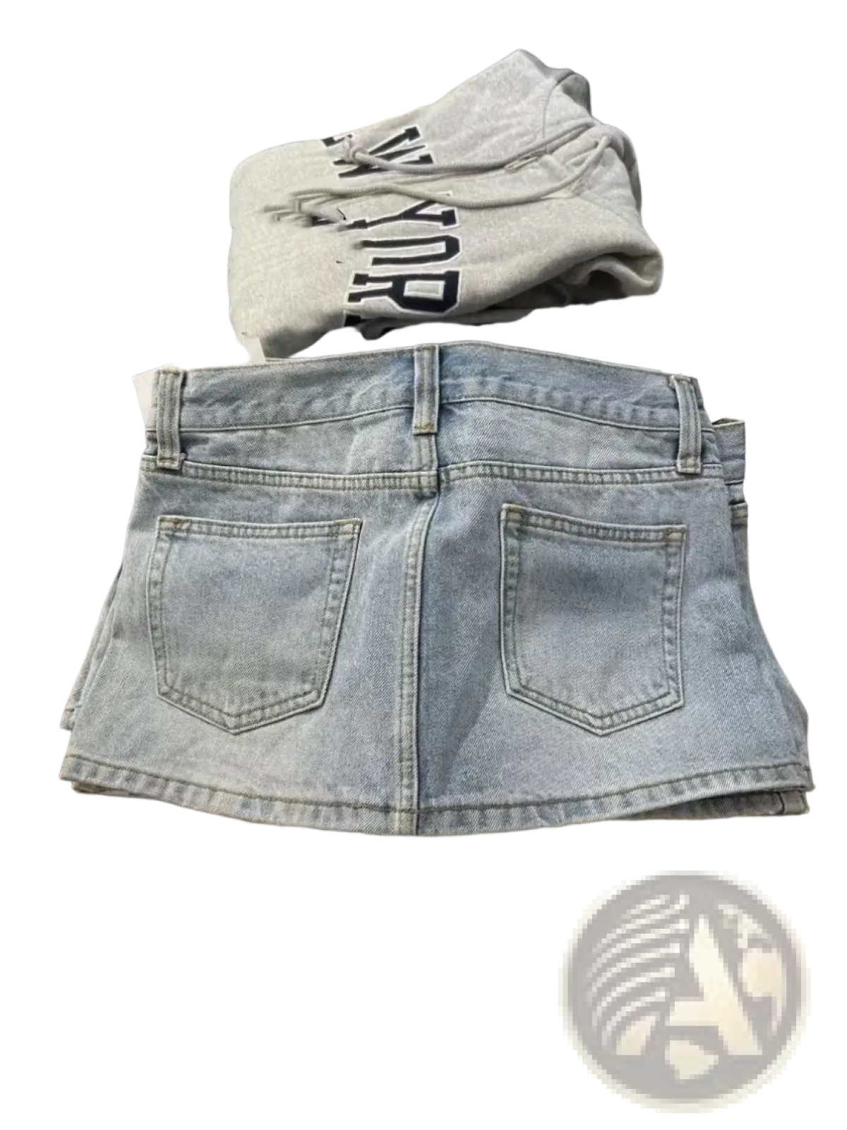 Back side of a light-wash blue denim mini skirt with high waist and classic pocket design for Y2K streetwear