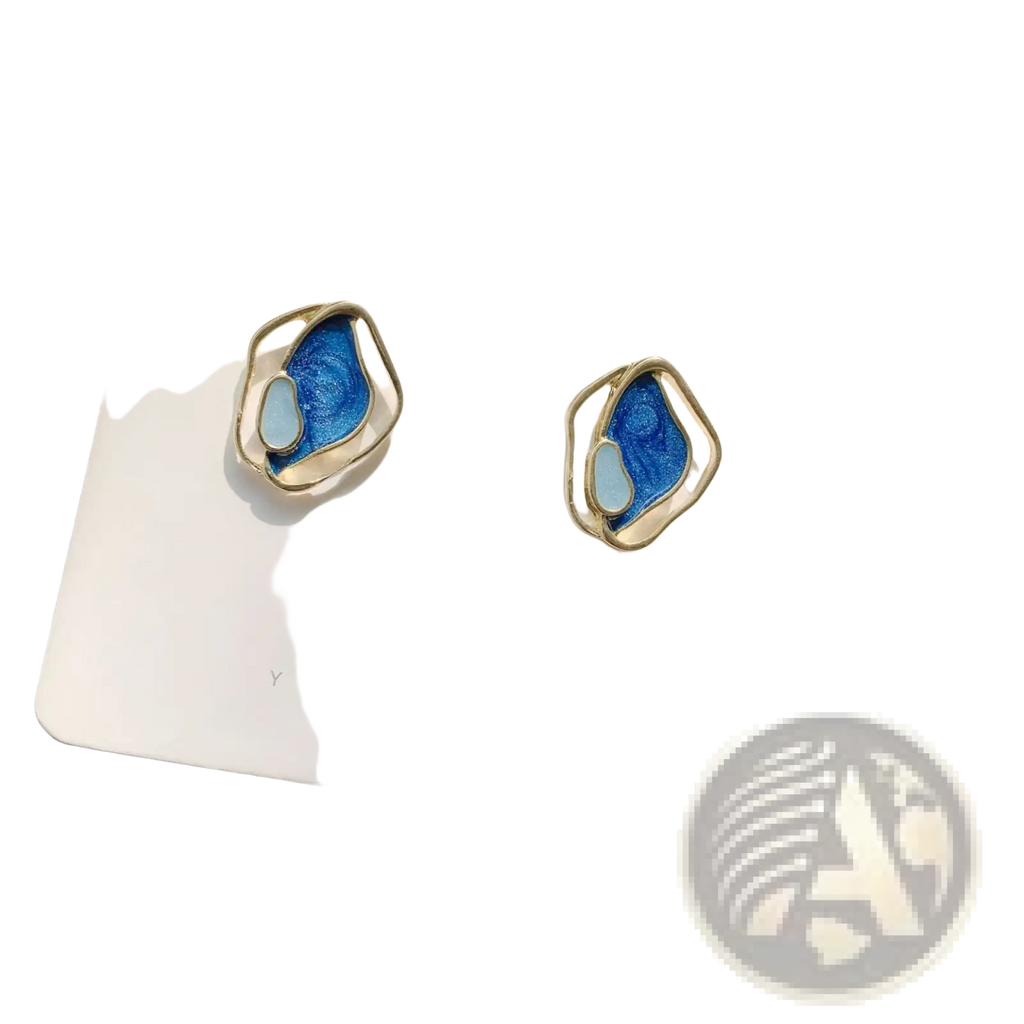 A pair of elegant blue enamel geometric silver stud earrings with gold-toned metal frames on a white card