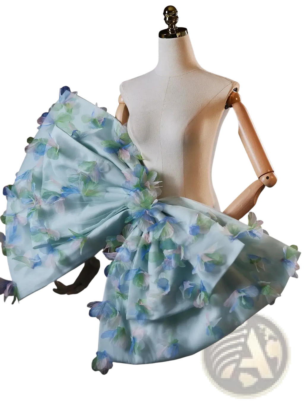A delicate light blue floral bridal dress with a voluminous ruffled skirt and matching oversized bow at the shoulder