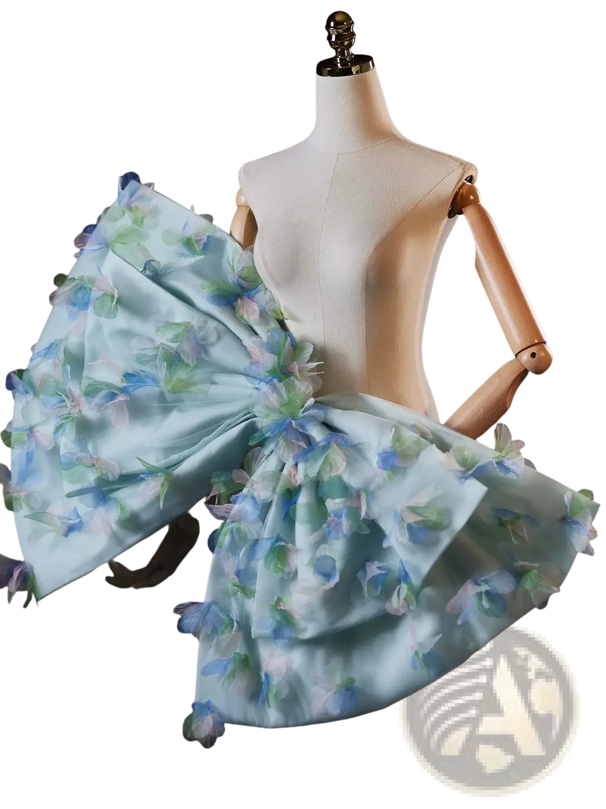 A delicate light blue floral bridal dress with a voluminous ruffled skirt and matching oversized bow at the shoulder