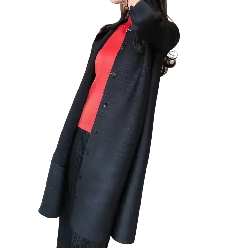 Black textured button-up coat worn over a red top paired with a blue knit trench coat women long button cardigan