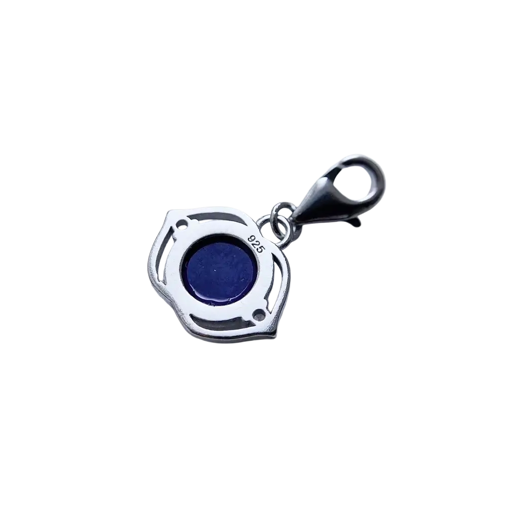 Blue lotus sterling silver charm pendant with deep blue lapis lazuli stone in ornate shield-shaped silver frame