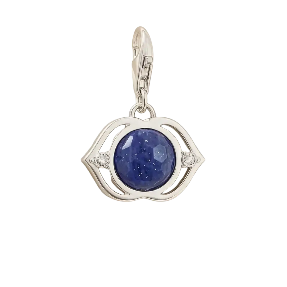 Blue lotus sterling silver charm pendant with silver eye shape and deep blue faceted gemstone accented by clear crystals