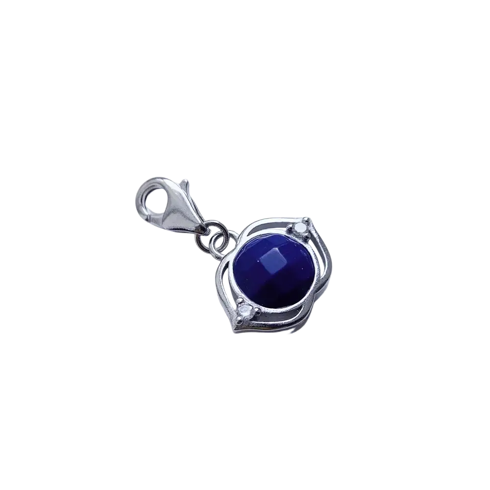 Blue Lotus sterling silver charm pendant with a deep blue faceted gemstone and ornate leaf-like frame accents
