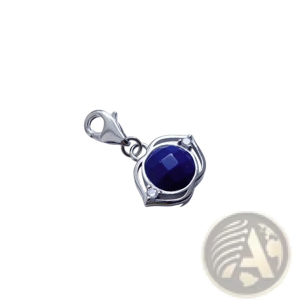 Blue Lotus sterling silver charm pendant with a deep blue faceted gemstone and ornate leaf-like frame accents