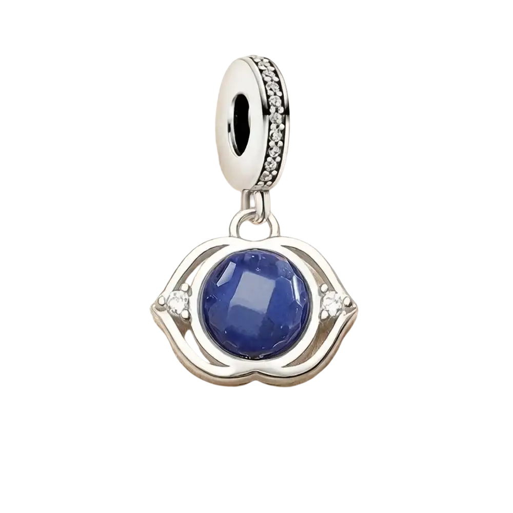 Blue Lotus sterling silver charm pendant with silver-toned eye shape and deep blue faceted gemstone center