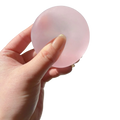 A translucent pink blue mochi squeeze sensory fidget toy held in hand designed for stress relief and tactile play